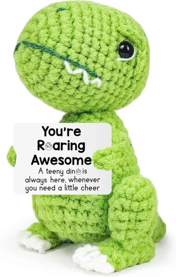 Green crochet dinosaur gift holding a personalized encouragement card