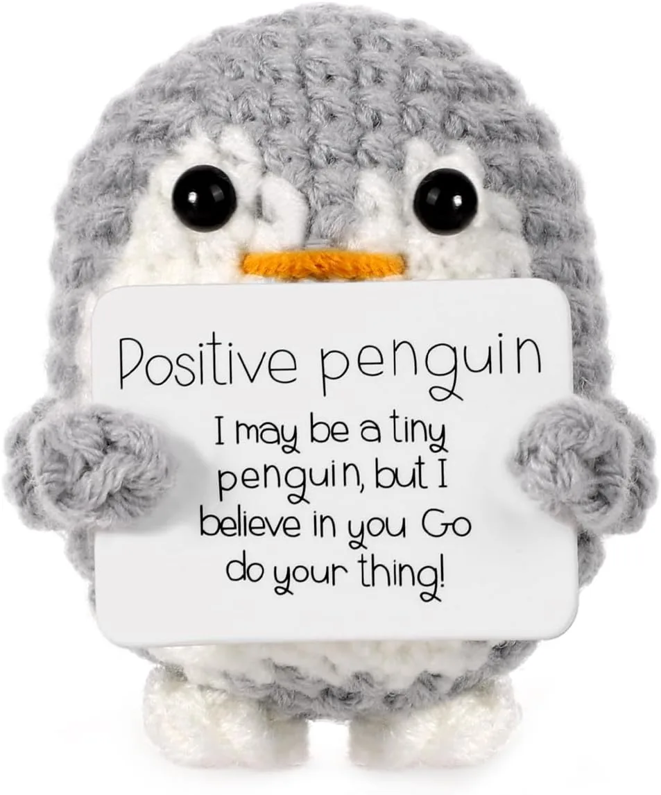 Gray crochet penguin gift holding a positive message card