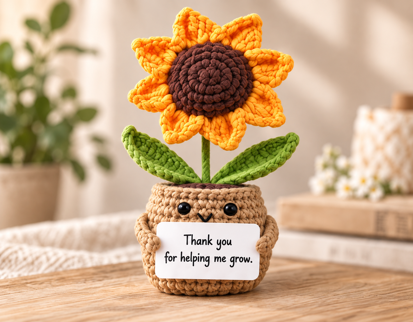 Crochet sunflower holding a “Thank you for helping me grow” card in a warm natural setting