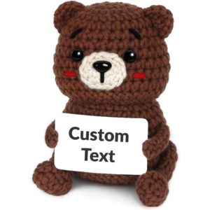 Brown crochet teddy bear holding a customizable message card — thank-you gift